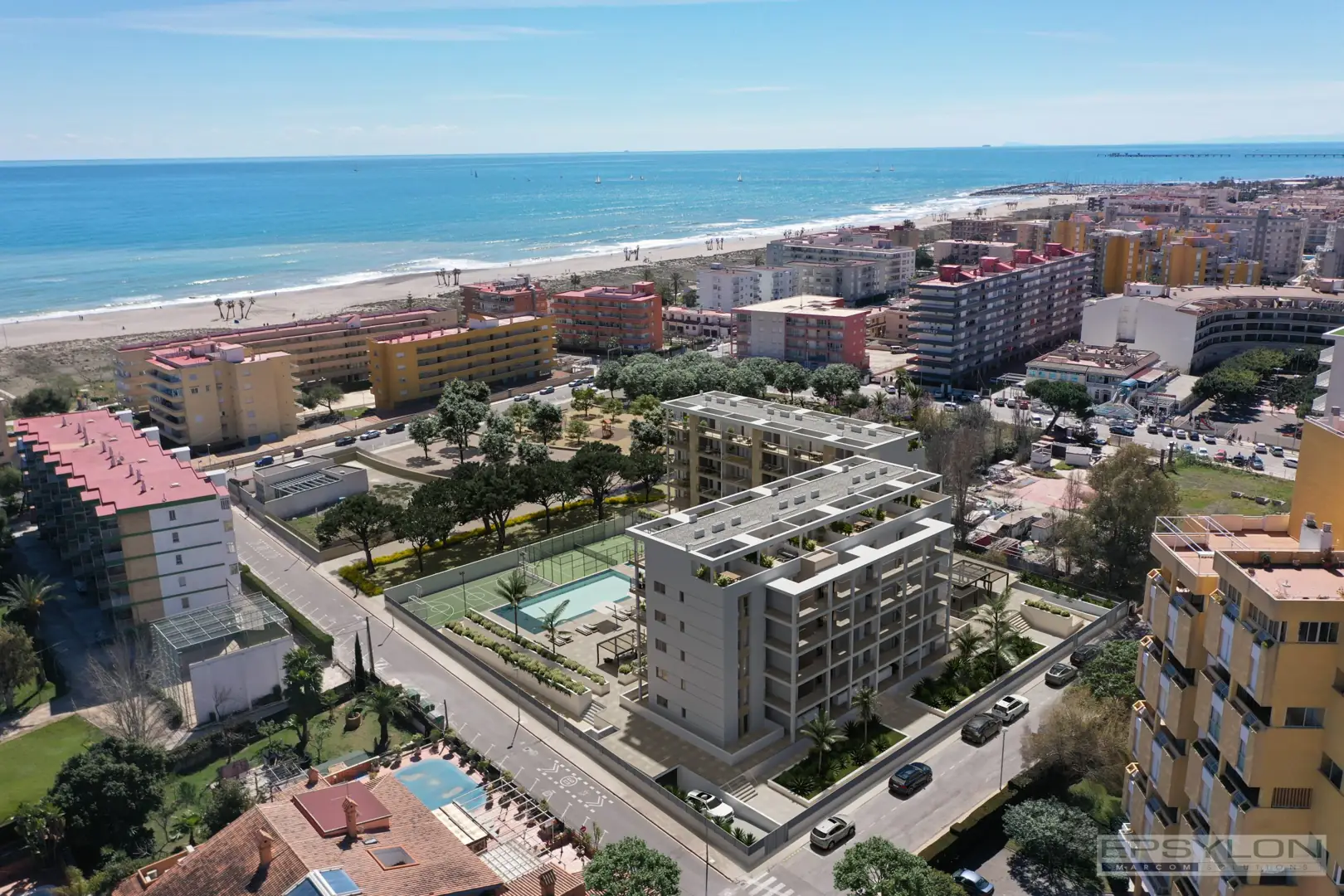 Vista aérea de promoción inmobiliaria en la costa, situada cerca de la playa con zonas comunes visibles